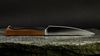 
                    Il coltello da bistecca dentato Caminada con manico di legno di noce del Prättigau
